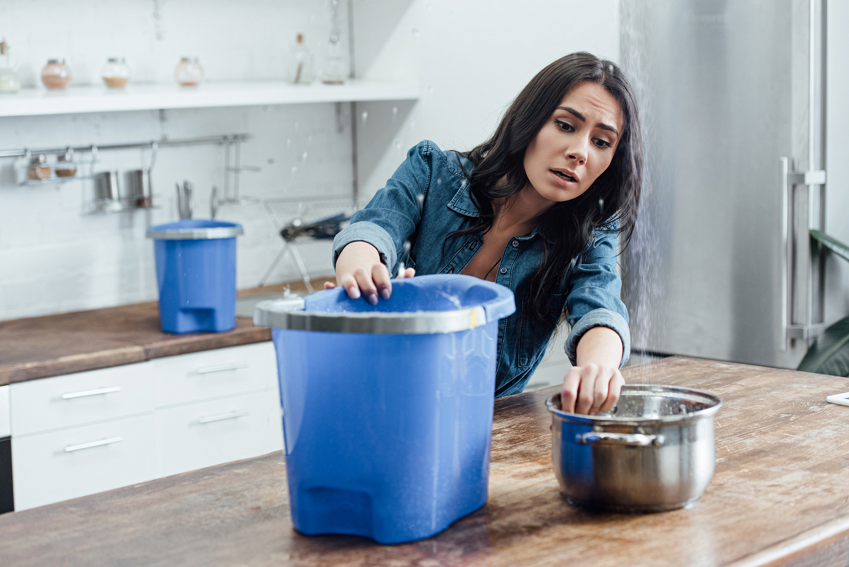 A woman dealing with a water leak