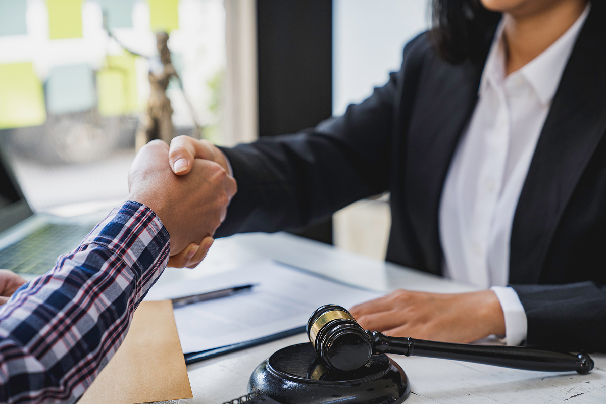 A lawyer shaking hands with a client